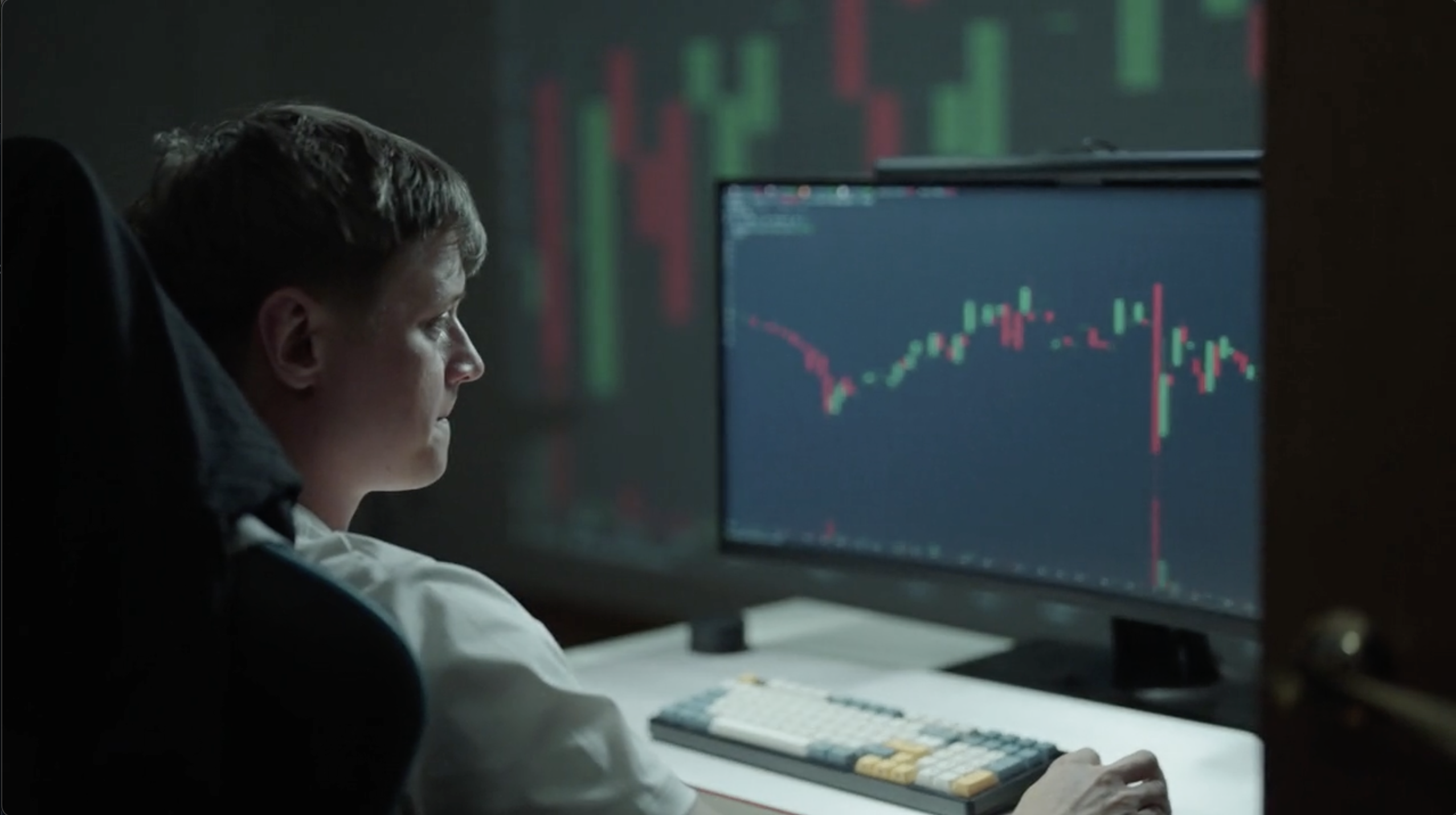 Trader alone staring at screens late at night